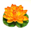 An artificial orange lotus flower with green leaves used for pond and garden decor.