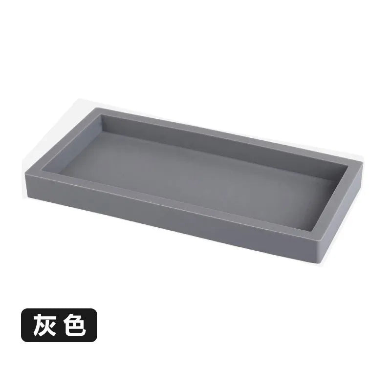 A rectangular gray silicone tray organizer for kitchen or bathroom use.