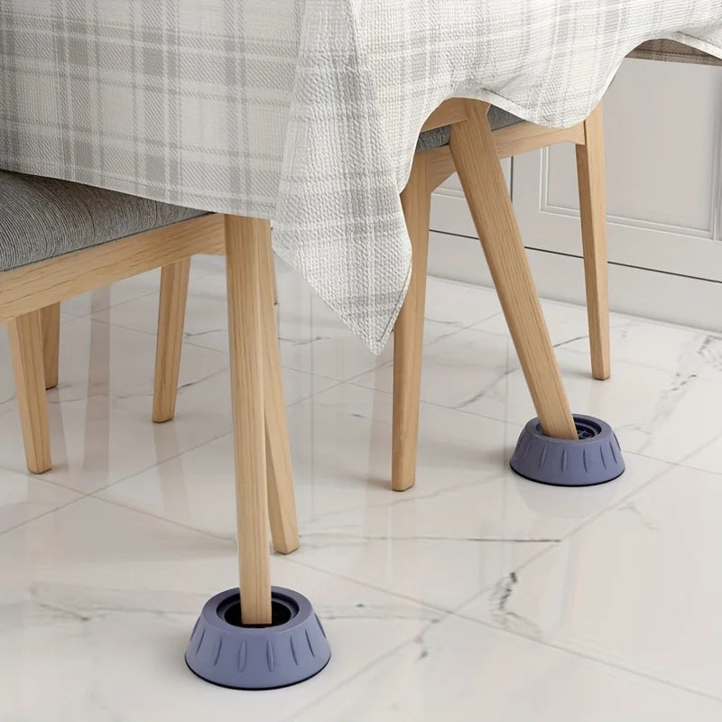 Anti-vibration feet for a wooden chair leg with a plaid fabric covering on a white marble floor