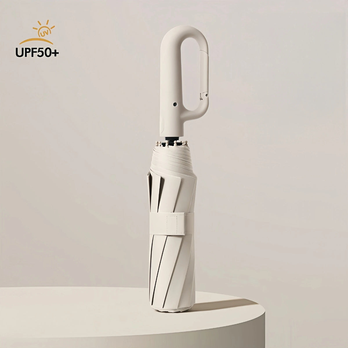 A white windproof automatic folding umbrella standing upright on a light surface.