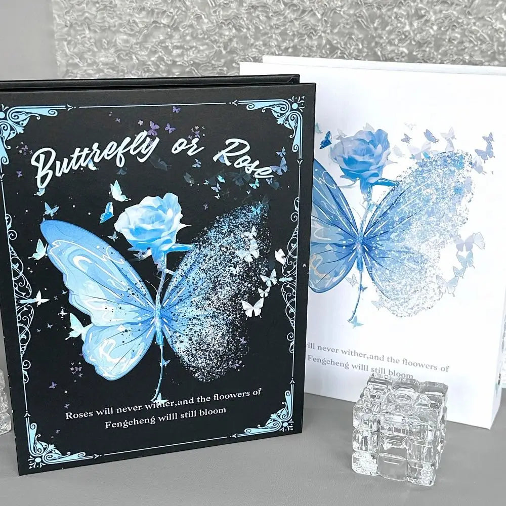 A black photo album cover featuring a blue butterfly and rose design with text on the front.