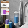 Set de brosses de toilette jetables murales avec des brosses parfumées blanc et lavande, exposées contre un mur gris.