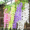 A hanging artificial wisteria garland featuring pink, yellow-green, purple, and white flowers.