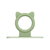 A light green silicone self-adhesive cabinet door handle lifter with a circular opening.
