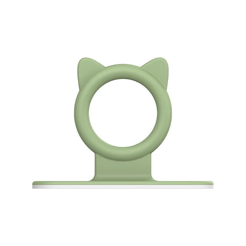 A light green silicone self-adhesive cabinet door handle lifter with a circular opening.