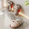 A collection of clear glass leakproof portable soap dishes with silver lids and red accents displayed on a white surface.