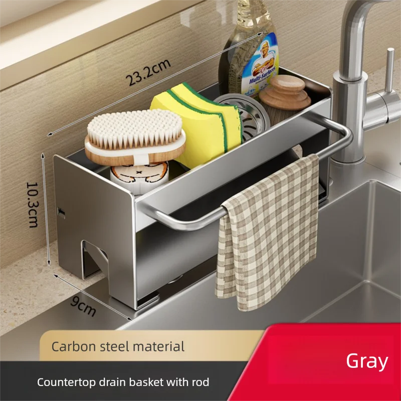 A stainless steel countertop drain basket with a rod holding sponges and dish tools.