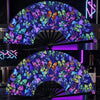 A holographic gradient rave hand fan with a vibrant purple and blue butterfly pattern displayed on a stand.