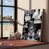 A vertical canvas art poster featuring multiple stylized faces in black and white tones displayed on a wooden shelf.
