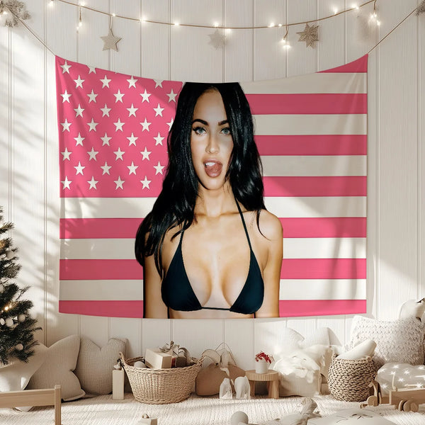 A woman posing in front of a pink and white striped American flag banner decorated with stars.