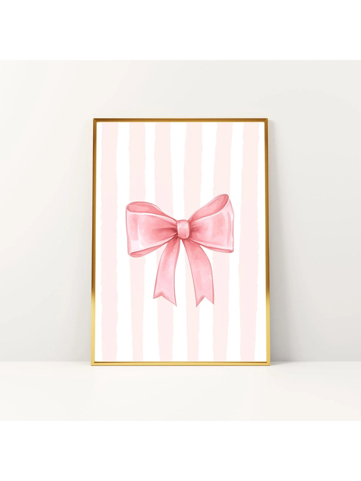 Pink striped canvas wall art featuring a pink bow in a gold frame for nursery decor