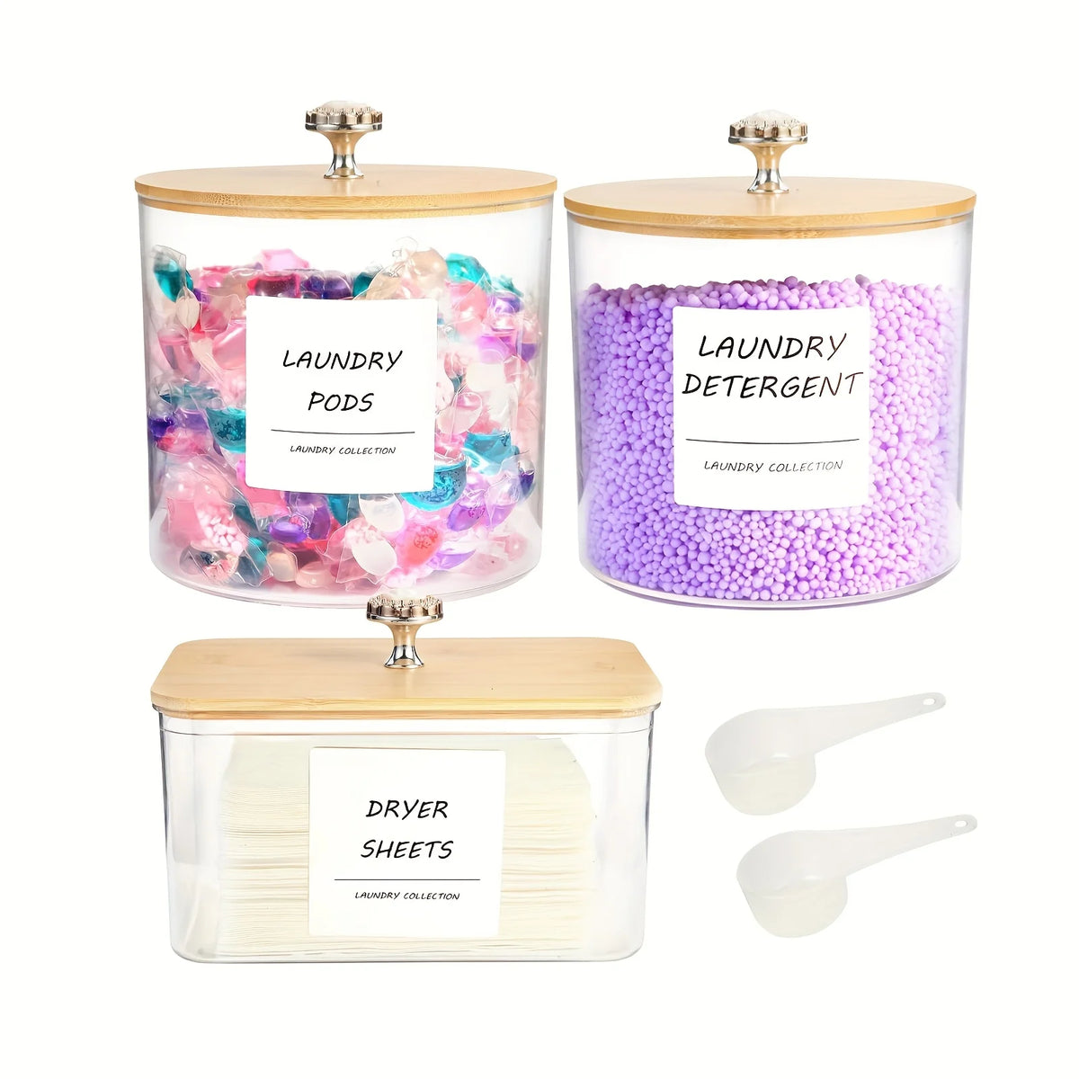 Three glass containers hold laundry detergent pods and dryer sheets with wooden lids.