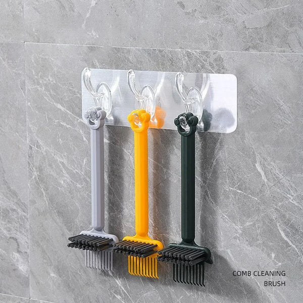 A white mounting plate holds three silicone comb cleaning brushes in gray, yellow, and black.