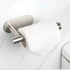 A silver wall mounted toilet paper holder with a white roll is shown against a white marble background.