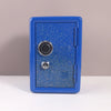 A blue metal piggy bank with a combination lock is shown against a neutral background.