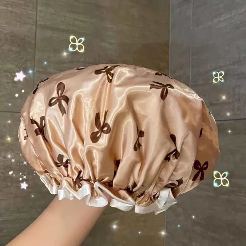 A light beige reusable double layer shower cap with brown floral patterns shown from above.