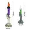 Skeleton hand Halloween LED candles featuring purple and green wax with orange flames