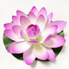 A vibrant pink artificial lotus flower blooming on a green leaf.