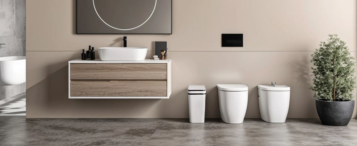 A modern bathroom vanity with a white vessel sink and a white automatic motion sensor trash can next to a potted plant.