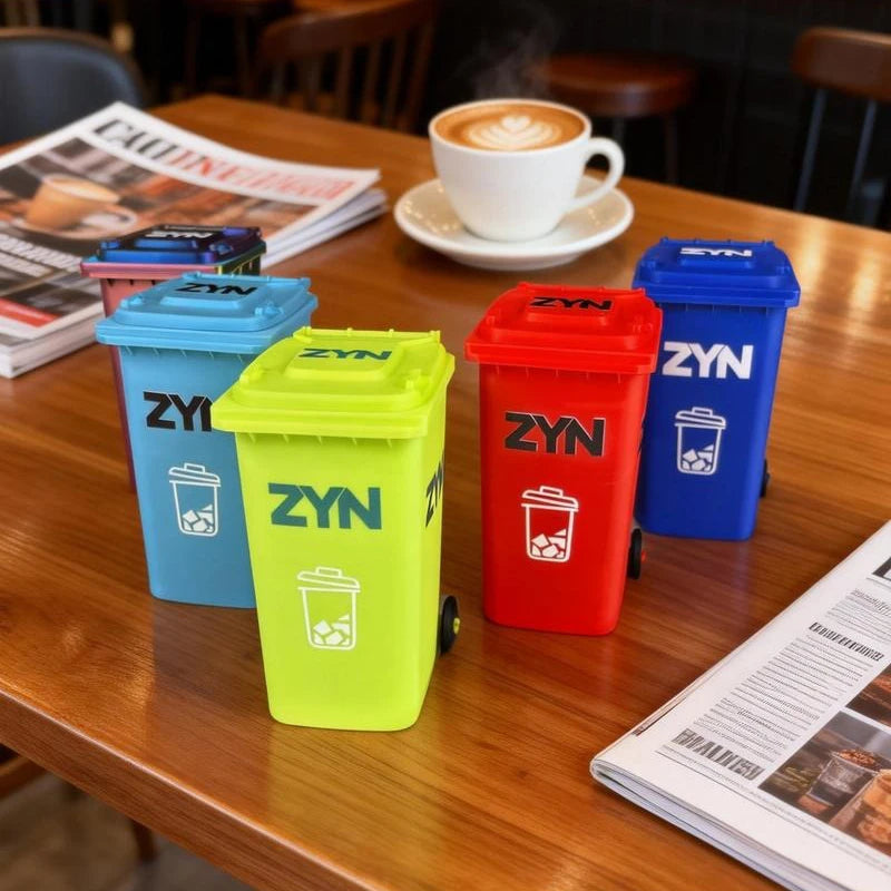 A row of colorful mini desk organizer trash cans, including blue, yellow, and red, sitting on a wooden table.