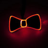 A glowing orange LED light-up bow tie shape against a dark background.