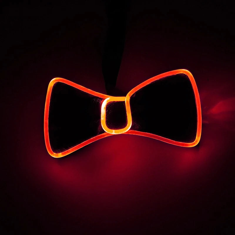 A glowing orange LED light-up bow tie shape against a dark background.