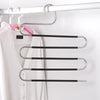 Stainless steel S-shaped drying rack hangers hanging on a white closet rod.