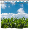 A set of dragonfly shower curtain hooks hanging against a bright blue sky and clouds above lush green foliage.