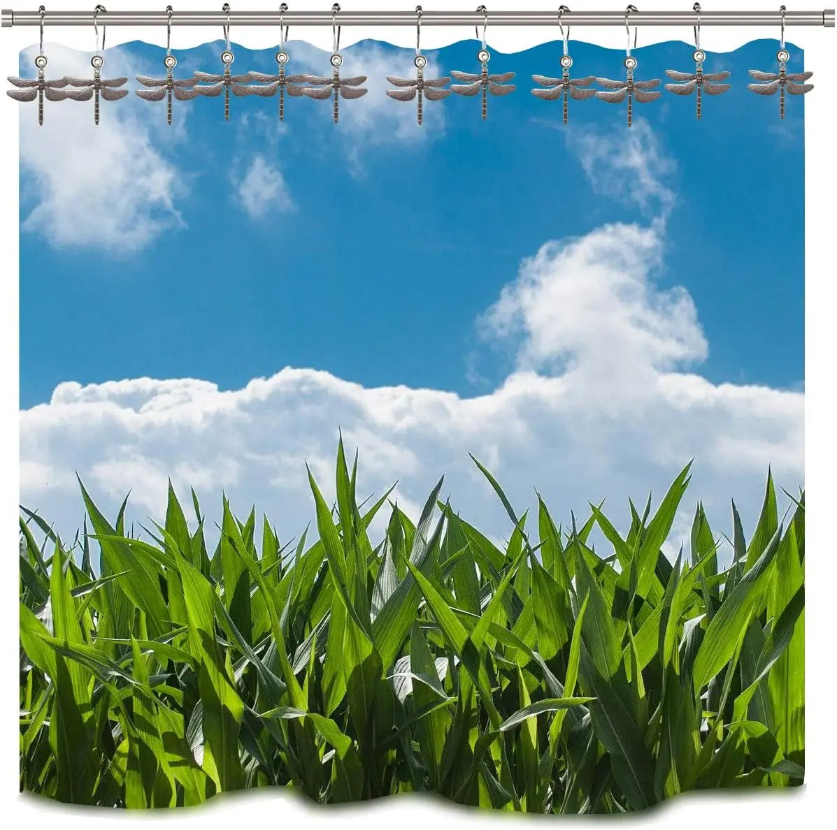 A set of dragonfly shower curtain hooks hanging against a bright blue sky and clouds above lush green foliage.