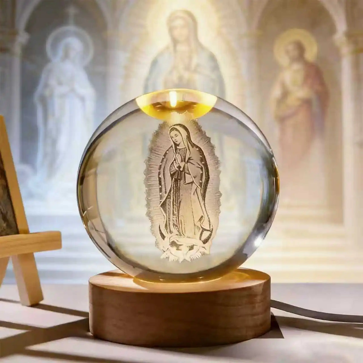 A clear glass crystal ball featuring an engraved image of the Virgin Mary, set on a wooden base.
