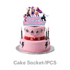 A pink birthday cake decorated with K-Pop themed figurines and a Happy Birthday topper.