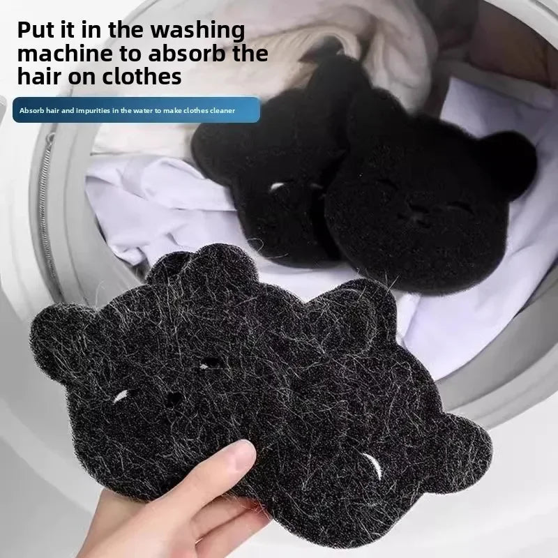 A hand is placing a black pet hair remover sponge into a washing machine to absorb hair on clothes.