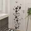 Decorative flower butterfly wall stickers on a white door in a bathroom or bedroom setting.