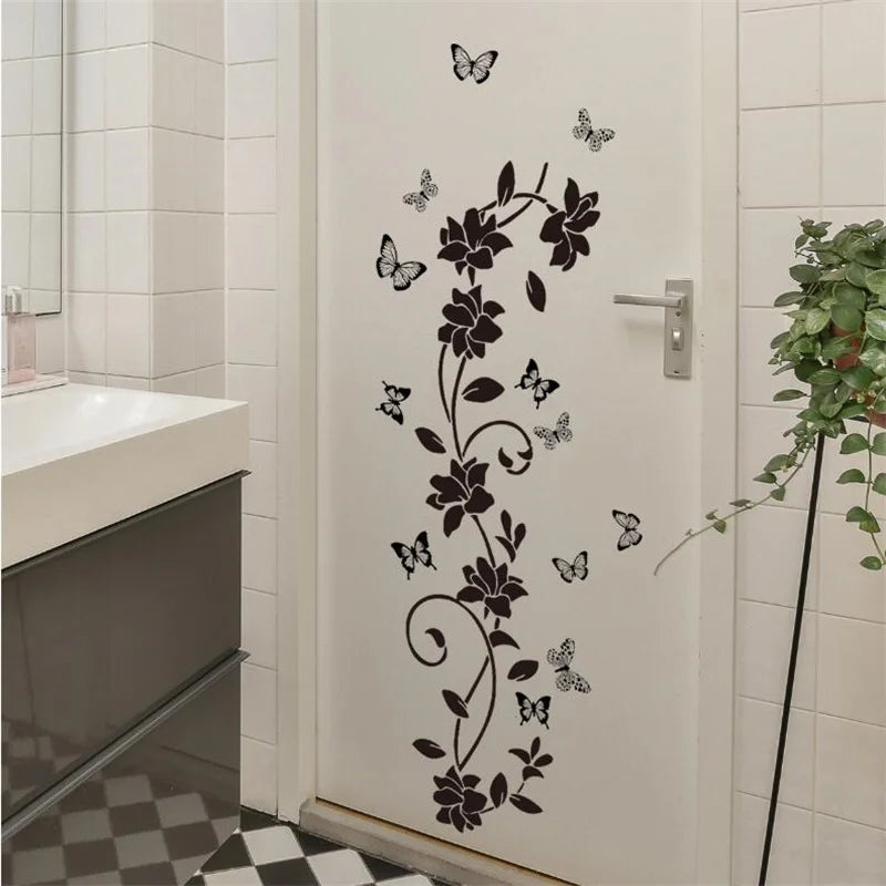 Decorative flower butterfly wall stickers on a white door in a bathroom or bedroom setting.