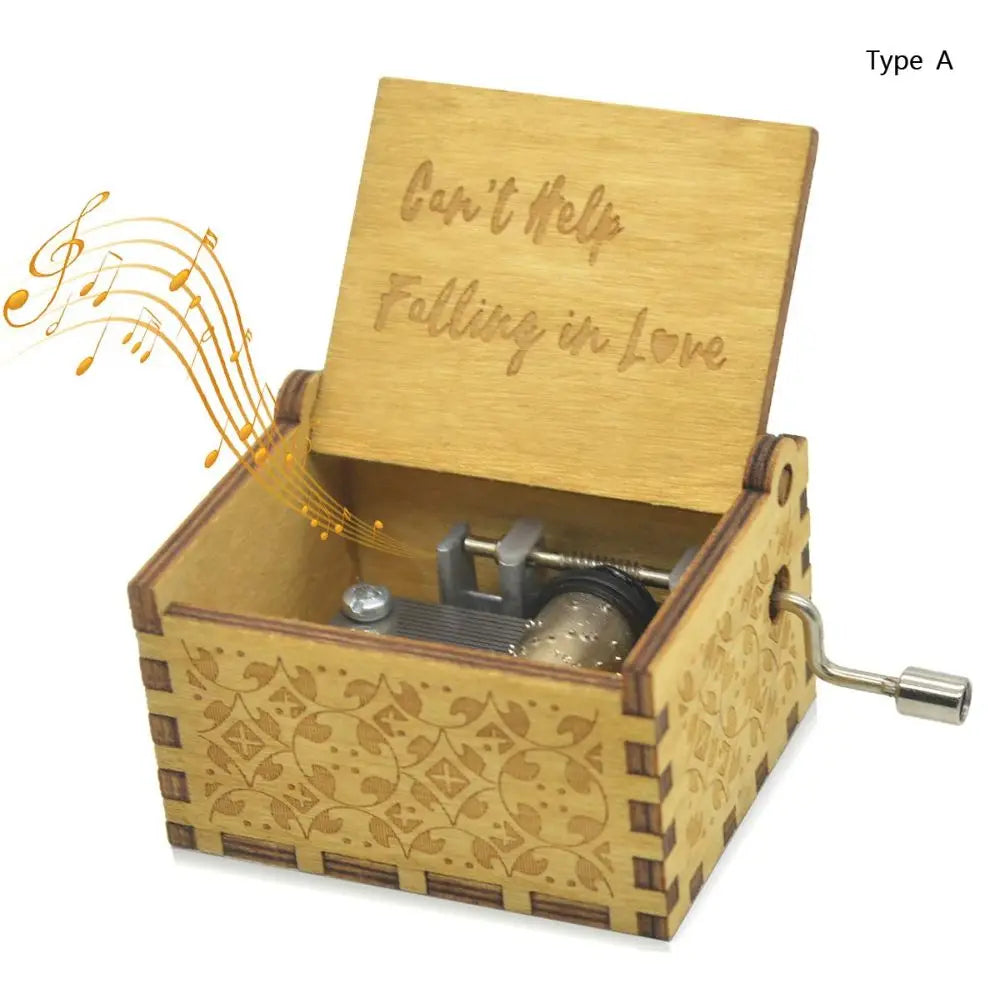 A wooden music box with an engraved lid that reads Can't Help Falling in Love and a small metal mechanism inside.