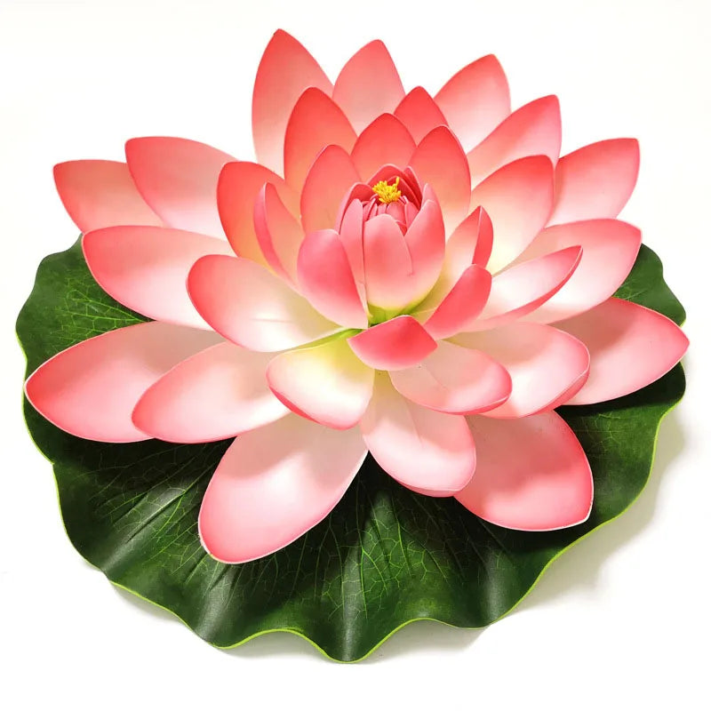 A vibrant pink artificial lotus flower with green leaves blooming in a full, layered arrangement.