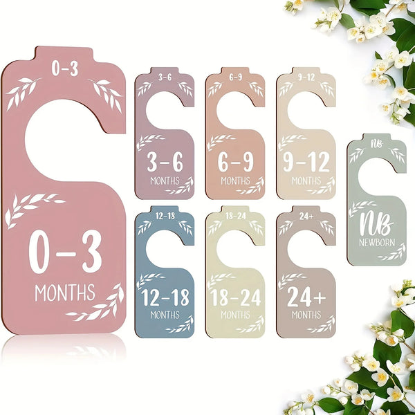 A set of wooden closet dividers for clothes organization showing age-based sections from 0-3 months to 24+ months.