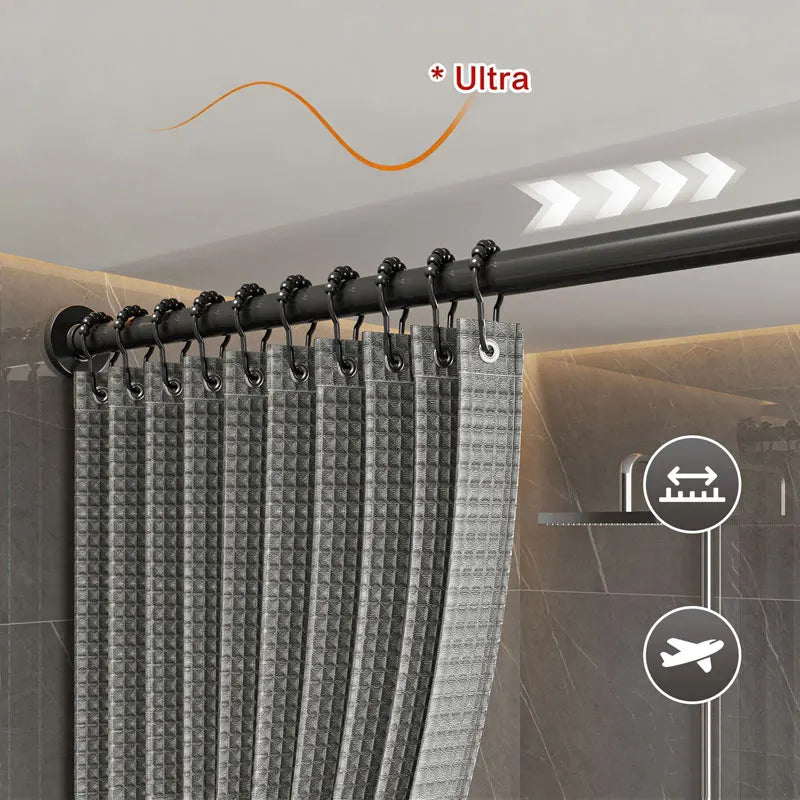 A close-up view of a black magnetic shower curtain with a waffle texture hanging on a rod.