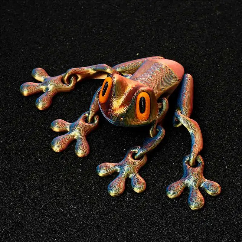 A detailed, metallic gold fidget frog with orange eyes is shown against a dark background.