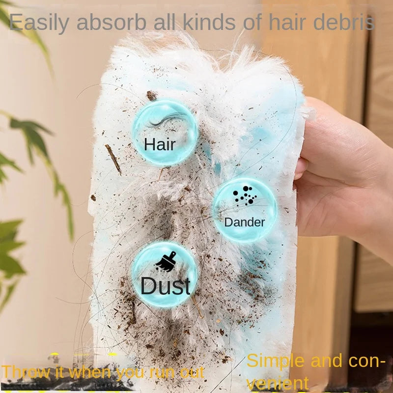 A hand holds a white, fluffy duster filled with hair debris, dust, and dander.