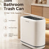 A white slim bathroom trash can with a one-touch open lid is shown on a marble countertop.