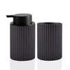 Black ceramic foaming soap dispenser with a pump top and a ribbed cylindrical body.
