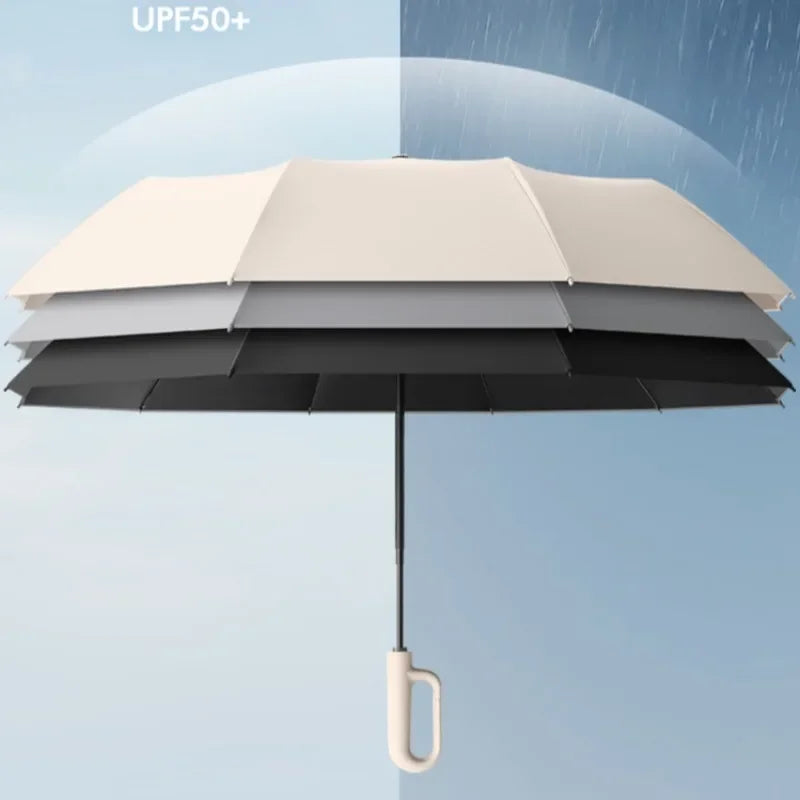 A black automatic folding umbrella with a beige canopy is shown against a light blue sky.