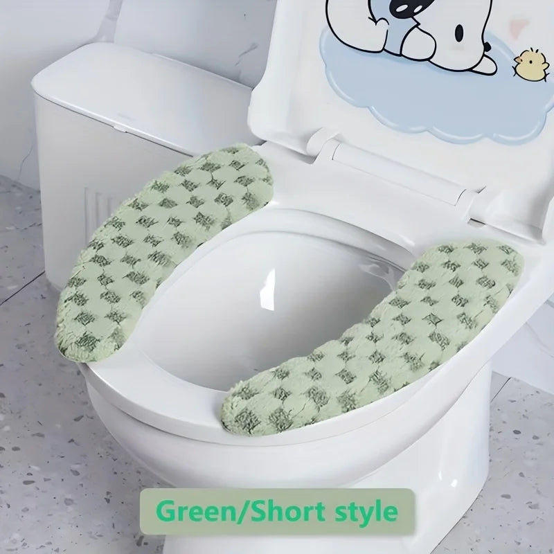 A white toilet features a green patterned short style seat cushion cover with a cartoon bear design.