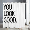 White shower curtain with black text that reads You Look Good.