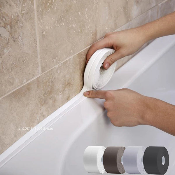 A hand is applying white self-adhesive waterproof sealing tape to the edge of a white bathtub or fixture.