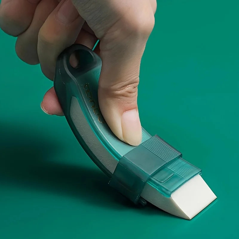 A hand holds a green reusable household stain remover eraser, showing its shape and texture.