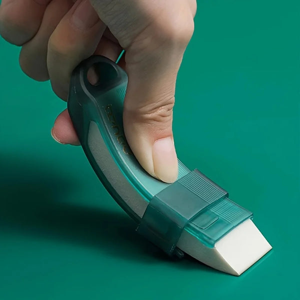 A hand holds a green reusable household stain remover eraser, showing its shape and texture.