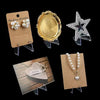 Three clear acrylic display stands showcasing gold and silver jewelry pieces.