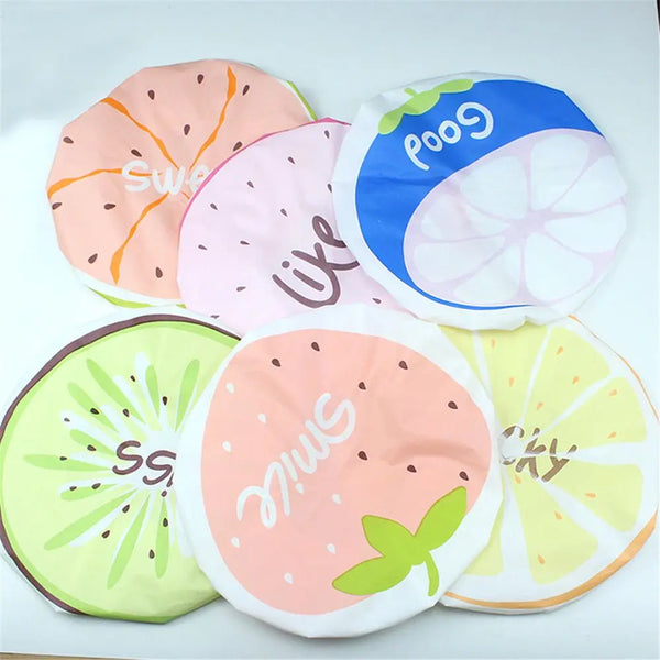 A collection of reusable fruit shower caps in various colors and designs featuring sliced fruits like watermelon, lime, and c